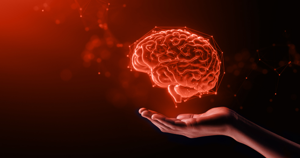 Brain floating above person's hand in orange lighting